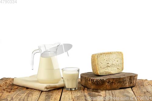 Image of Different milk products, cheese, cream, milk on wooden table and white background.