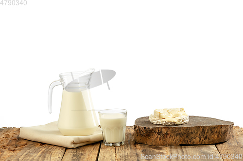 Image of Different milk products, cheese, cream, milk on wooden table and white background.