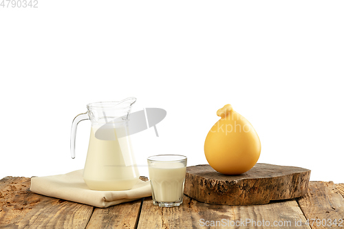 Image of Different milk products, cheese, cream, milk on wooden table and white background.