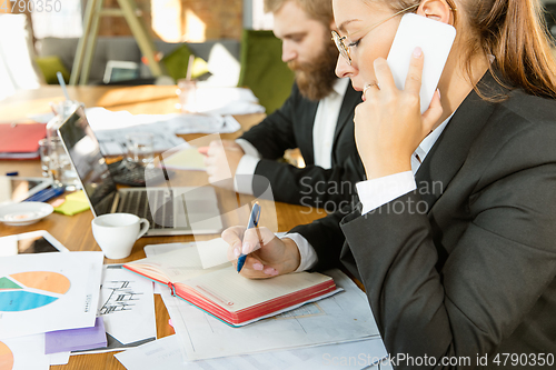 Image of Group of young business professionals having a meeting, creative office