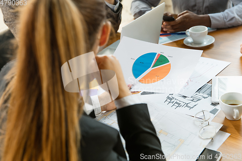 Image of Group of young business professionals having a meeting, creative office