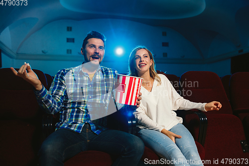 Image of Attractive young caucasian couple watching a film at a movie theater