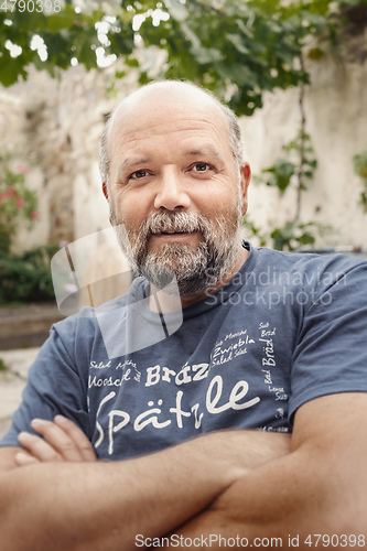 Image of nice guy bearded male man portrait in the backyard