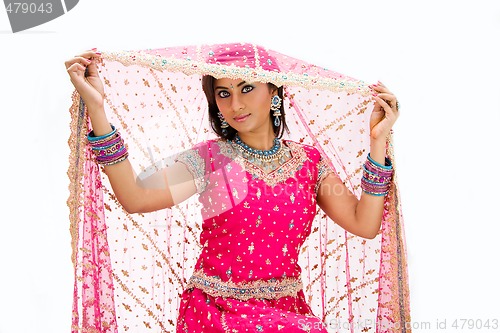 Image of Beautiful Bangali bride lifting veil