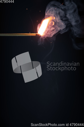 Image of match flame dark background