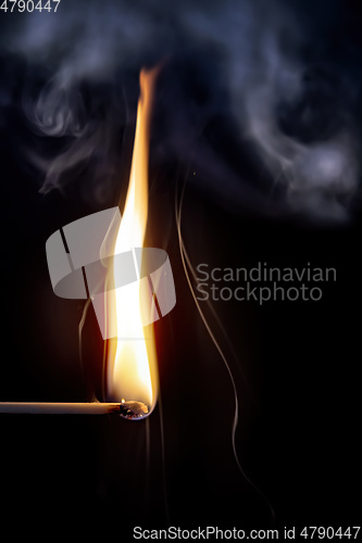 Image of match flame dark background