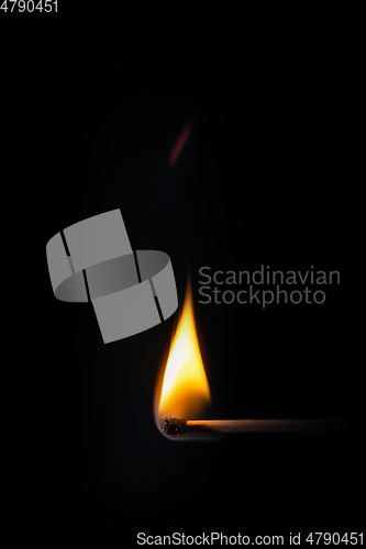 Image of match stick flame in front of a black background