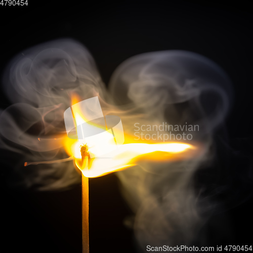 Image of match flame dark background