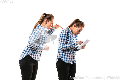 Image of Young handsome woman arguing with herself on white studio background.