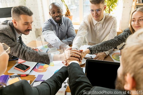 Image of Group of young business professionals having a meeting, creative office