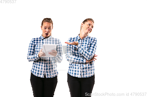 Image of Young handsome woman arguing with herself on white studio background.