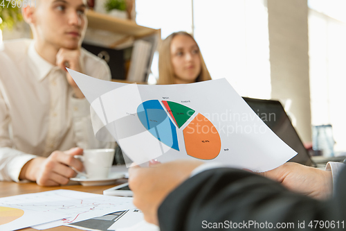 Image of Group of young business professionals having a meeting, creative office
