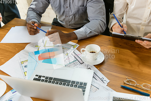 Image of Group of young business professionals having a meeting, creative office