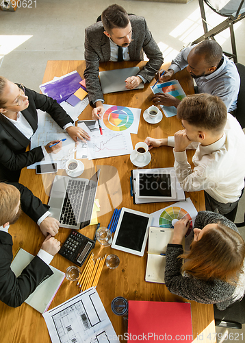 Image of Group of young business professionals having a meeting, creative office