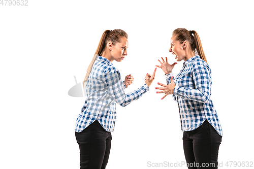 Image of Young handsome woman arguing with herself on white studio background.