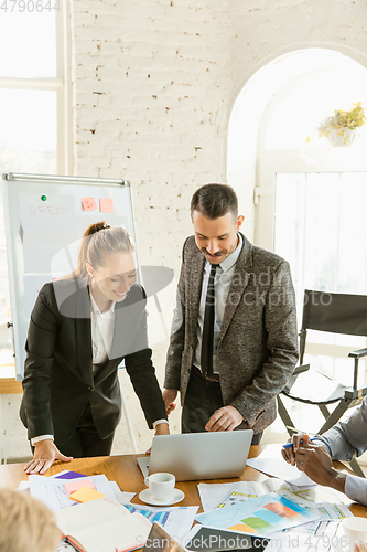 Image of Young business professionals having a meeting, creative office