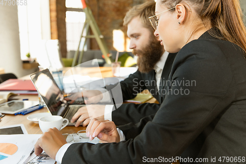 Image of Group of young business professionals having a meeting, creative office
