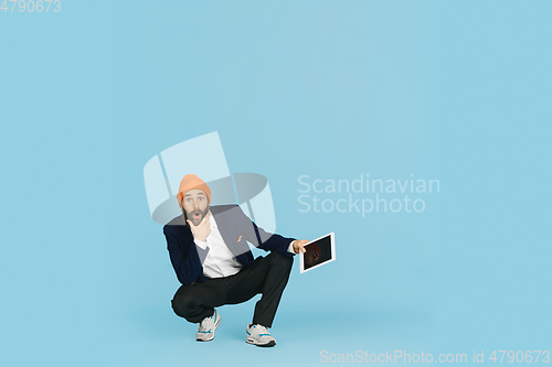 Image of Businessman having fun dancing break dance on blue background at work