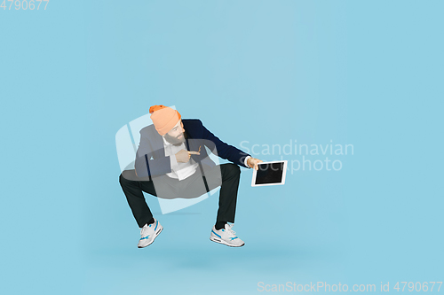 Image of Businessman having fun dancing break dance on blue background at work