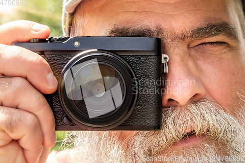 Image of older man with his camera