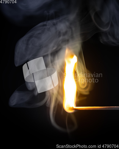 Image of match flame dark background