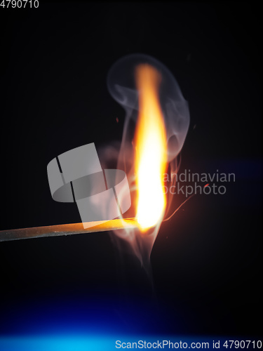 Image of match flame dark background