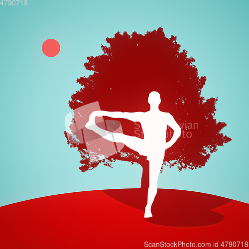 Image of yoga standing pose in front of a tree