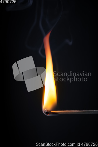 Image of match flame dark background