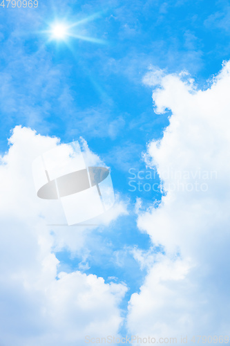 Image of typical blue sky with sun and clouds background