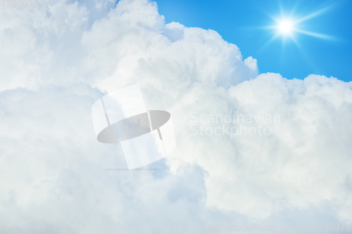 Image of typical blue sky with sun and clouds background