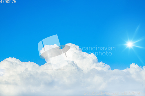 Image of typical blue sky with sun and clouds background