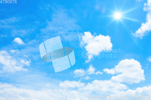 Image of typical blue sky with sun and clouds background