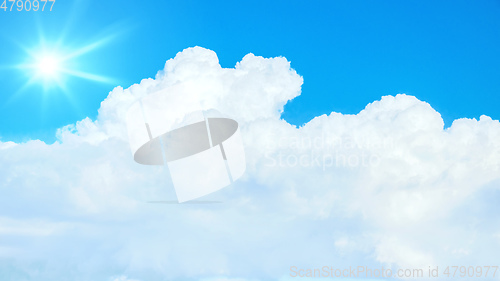 Image of typical blue sky with sun and clouds background