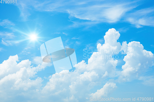 Image of typical blue sky with sun and clouds background