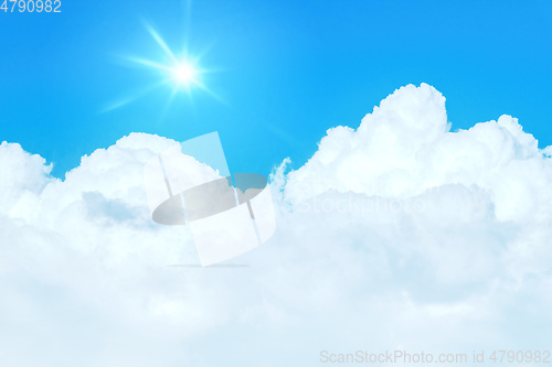 Image of typical blue sky with sun and clouds background