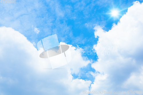 Image of typical blue sky with sun and clouds background
