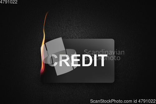 Image of burning credit card on black background