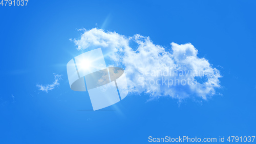 Image of typical blue sky with sun and clouds background