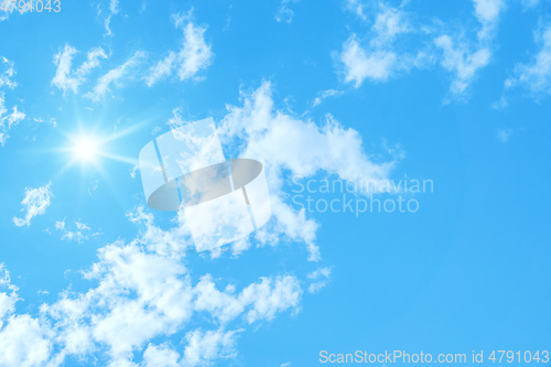 Image of typical blue sky with sun and clouds background