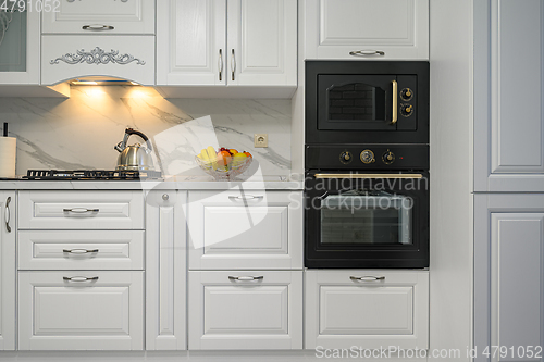 Image of White kitchen in classic style, front view