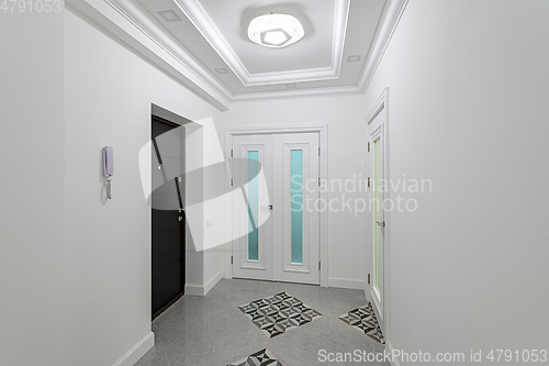 Image of interior of white hallway with doors