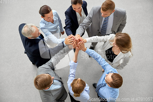 Image of business people making high five in office