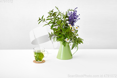 Image of herbal tea and flowers in jug