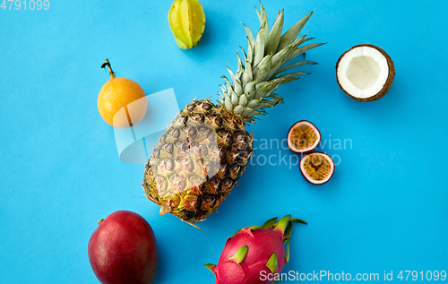 Image of pineapple with other fruits on blue background