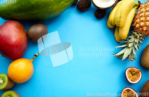 Image of different exotic fruits on blue background