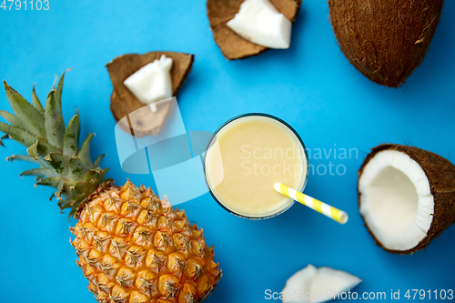 Image of pineapple, coconut and drink with paper straw