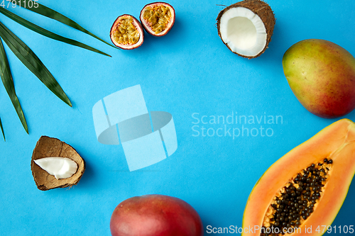 Image of different exotic fruits on blue background