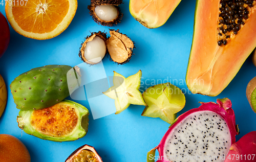 Image of different exotic fruits on blue background