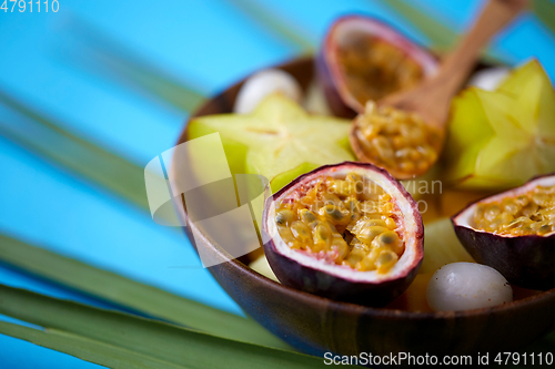Image of close up of of exotic fruits mix with wooden spoon