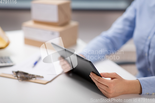 Image of close up of woman with tablet pc at post office